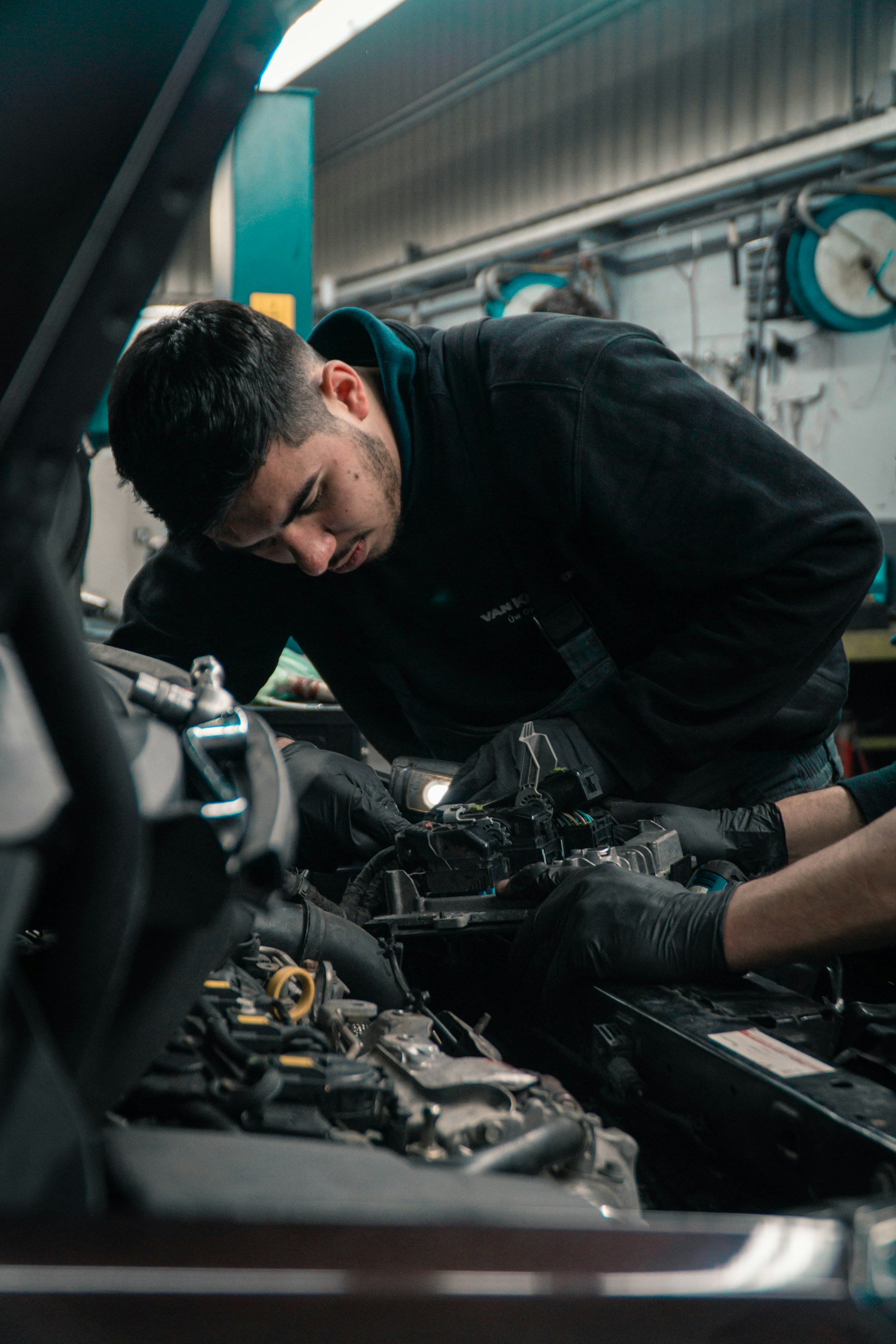 A technician working under the hood, finding the real problem before quoting